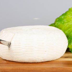 Sliced wheel of Stenby cheese